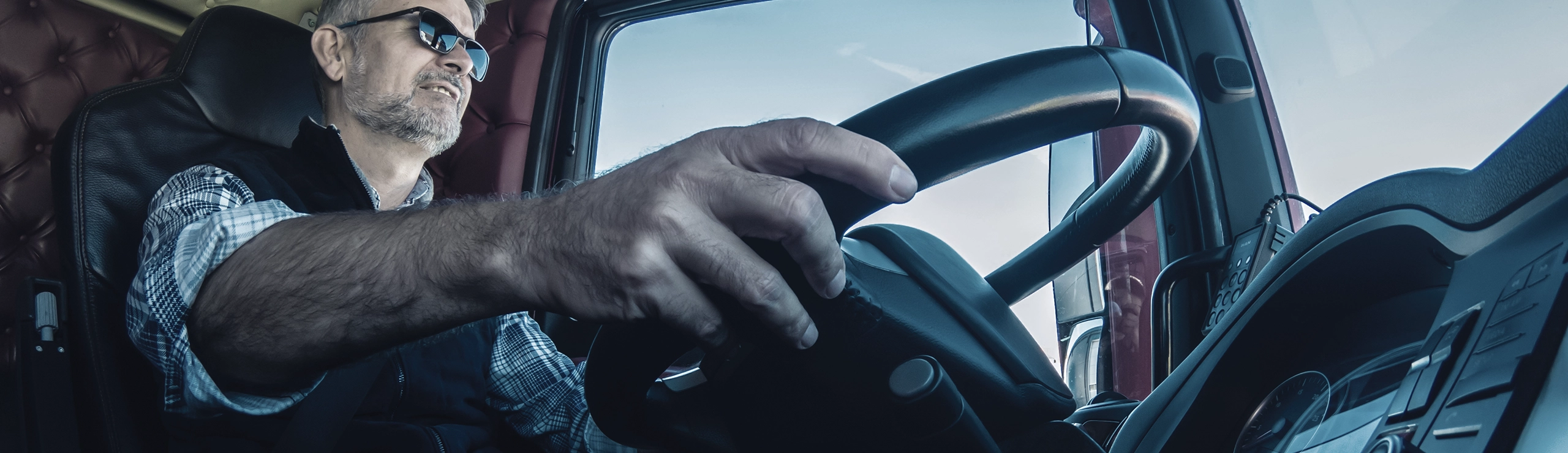 Priority Logistics driver behind truck wheel 